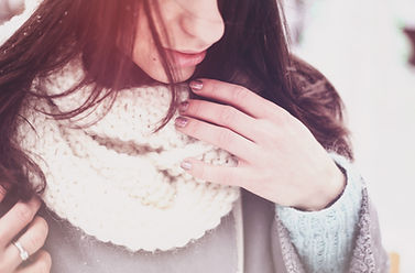Girl in a white knitted wool scarf