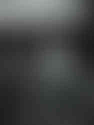 Black and white photo of a bride and groom doing their cake cutting at their backyard wedding