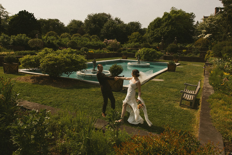 A bride and groom dancing in documentary style wedding photography at Planting Fields Aboretum