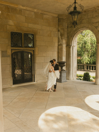 A bride and groom dancing in the West Portico at Planting Fields Arboretum