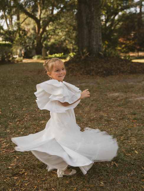 A flower girl spinning in her dress
