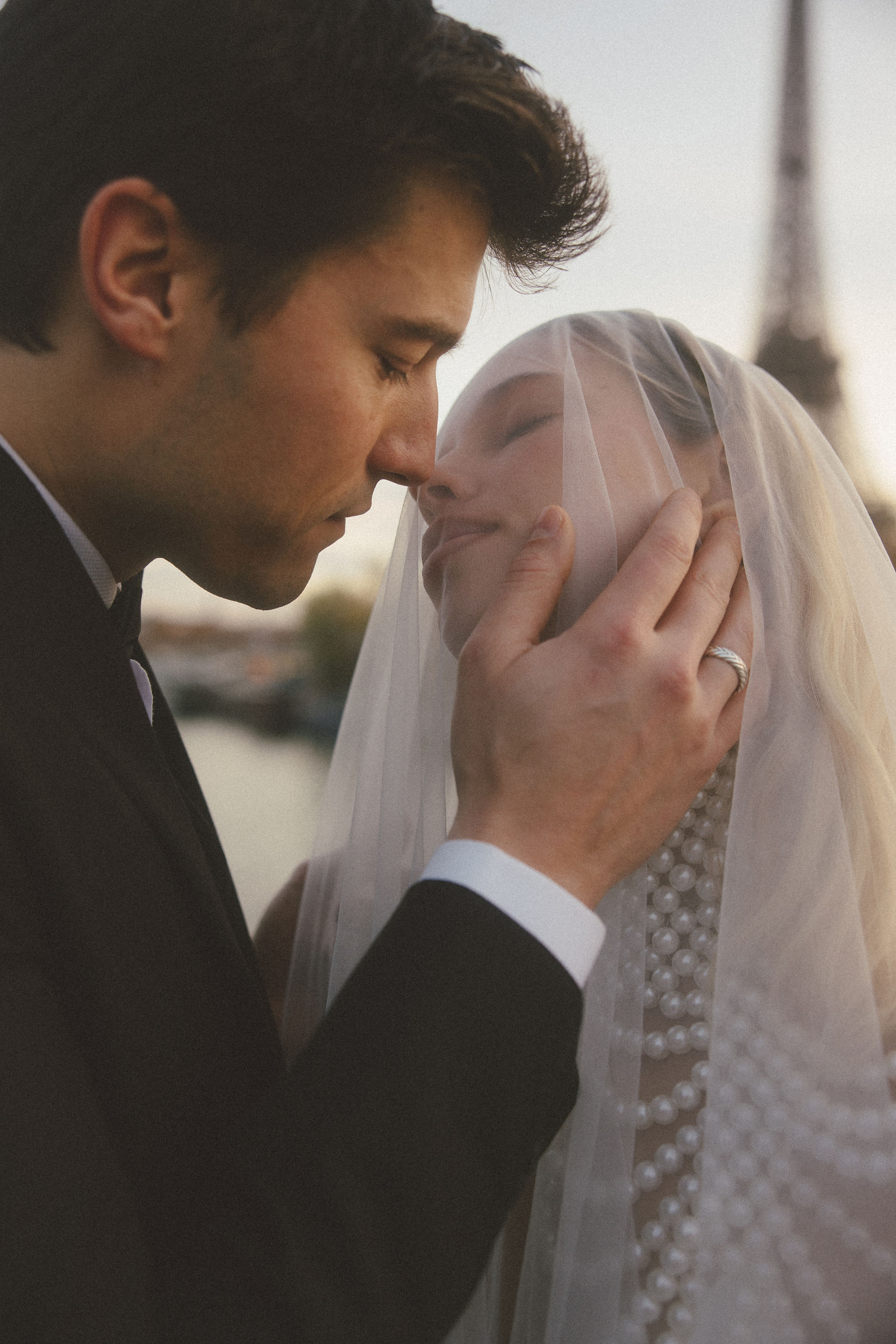 A man leaning in to kiss his wife