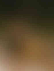 A wedding reception table setup at a backyard wedding with a pitcher, flowers, and table numbers