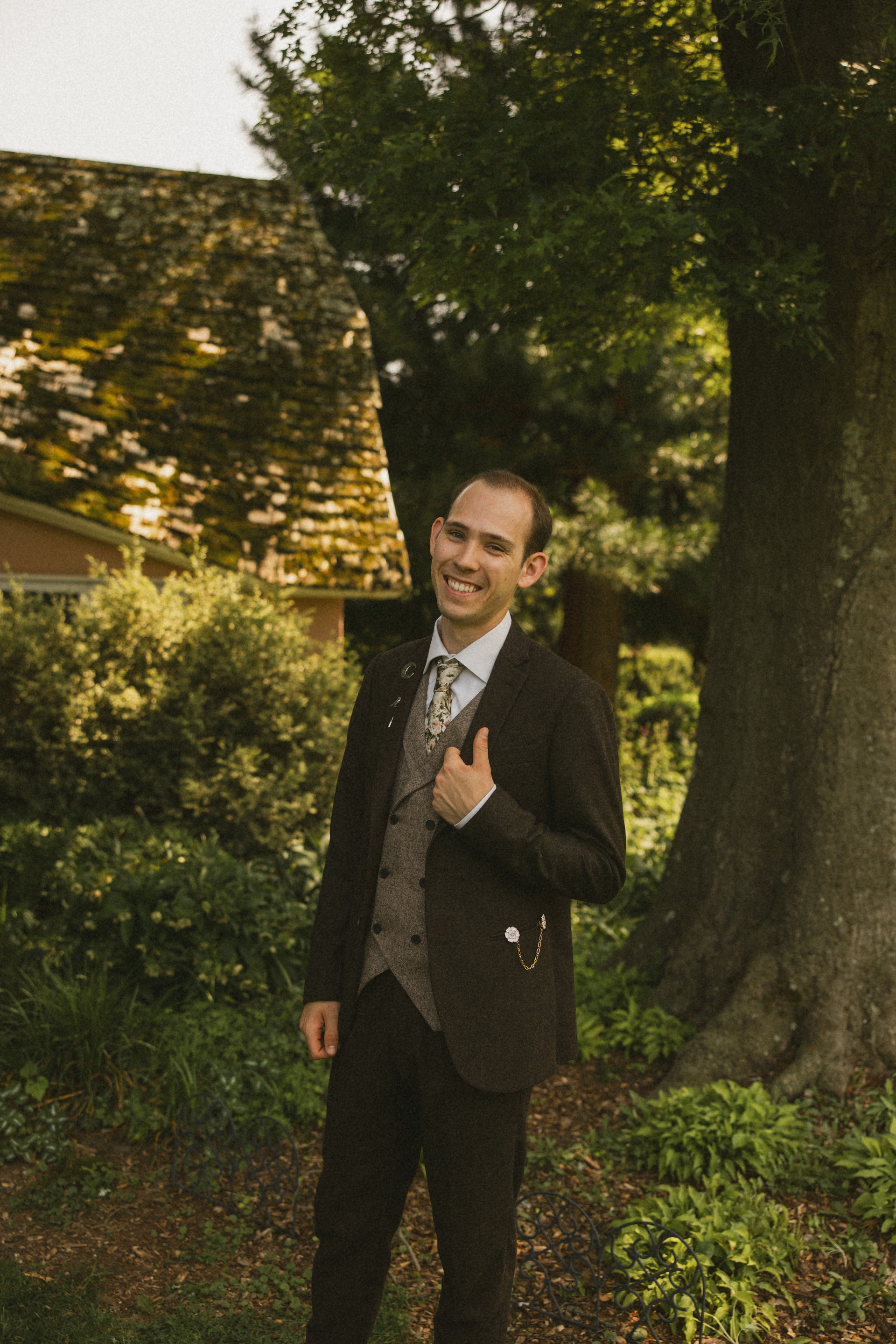 A groom smiling for a wedding portrait