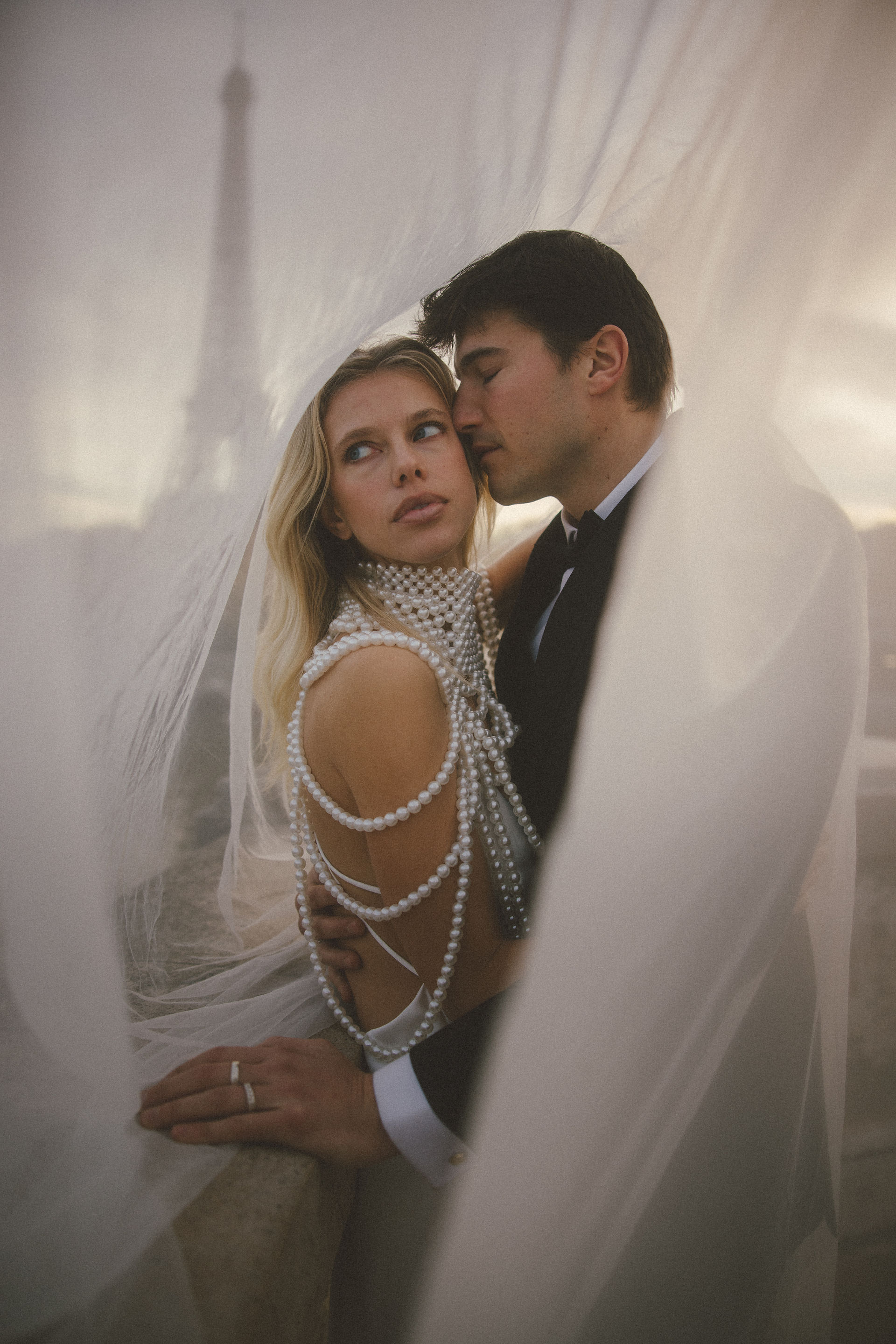 A couple underneath a veil for their Paris elopement photos