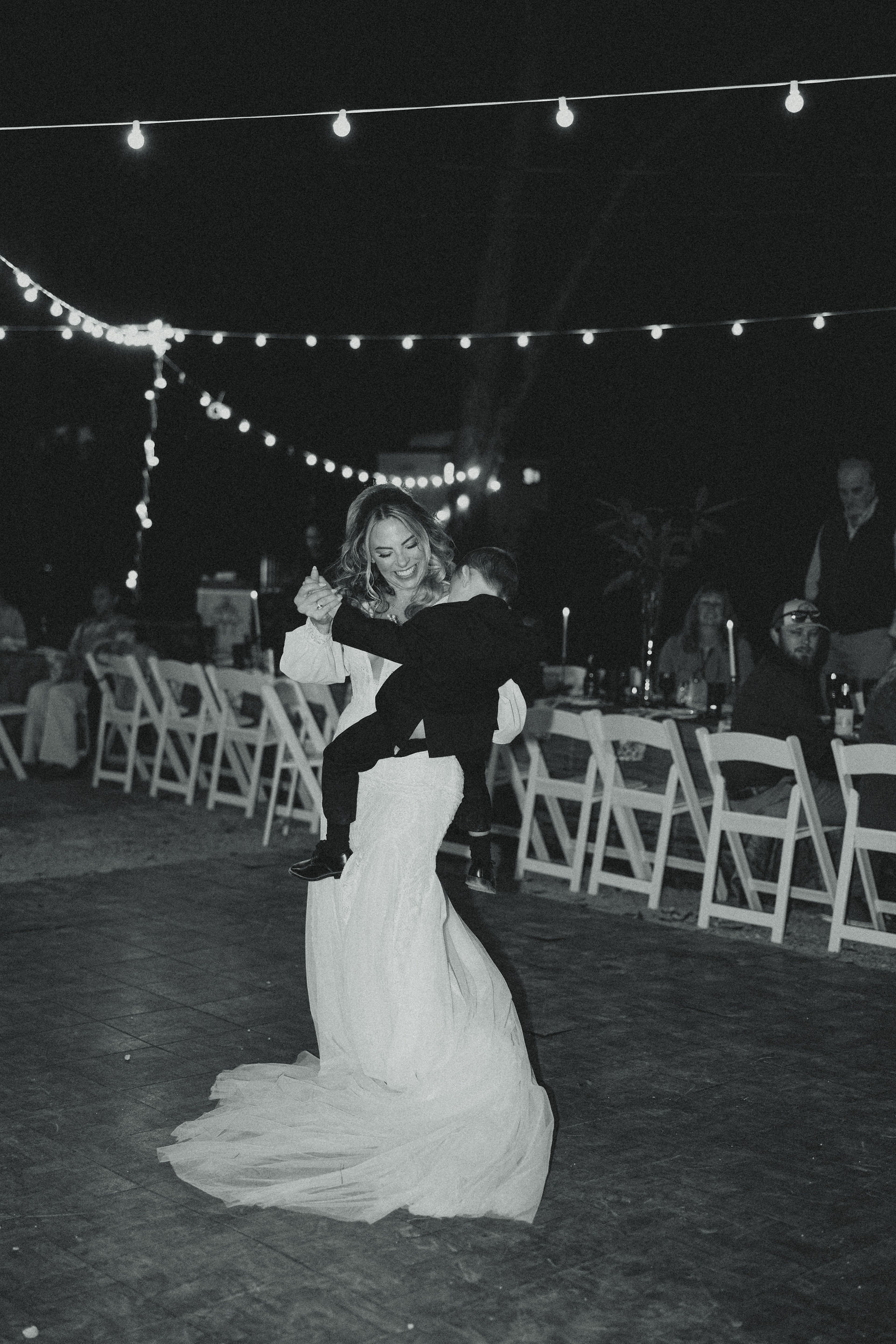 A bride dancing with her son at a wedding reception
