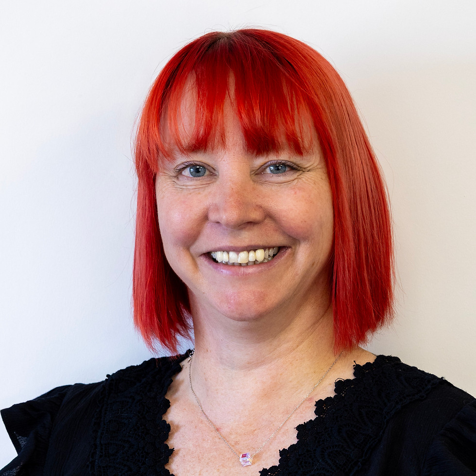 Smiling red haired woman wearing black shirt