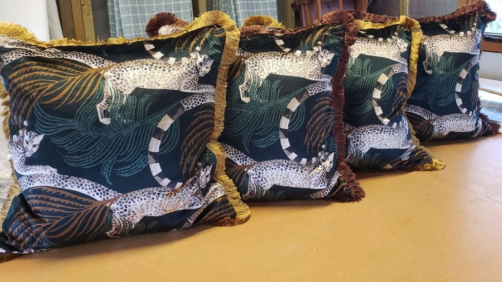 Cushions with leopard pattern and fringing.
