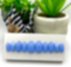 short oval press-on nails in sky blue color on a nail display