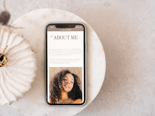Smartphone on a white surface showing an "About Me" page with a woman's photo. Beside it is a decorative, beige pumpkin. Neutral background.