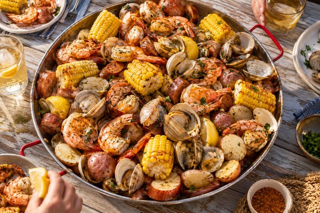 Illustration: Lowcountry Seafood Boil. Fictional scene; not a photograph of this business or its actual menu.