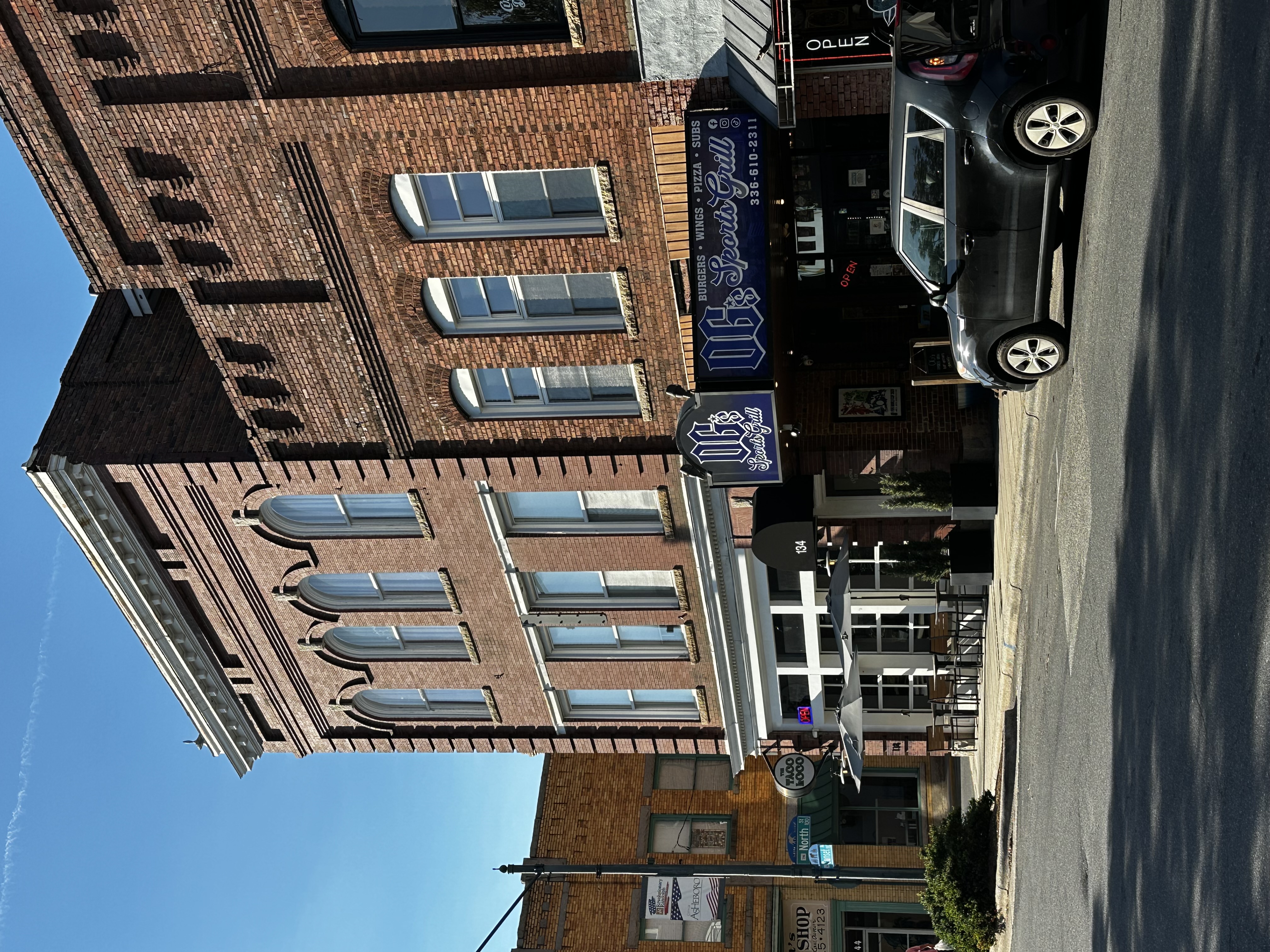 OG’s Sports Grill sign and brick storefront beside Taco Loco in Asheboro.