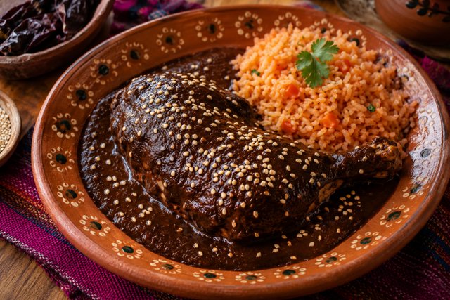 Illustration: Mole Poblano. Fictional scene; not a photograph of this business or its actual menu.