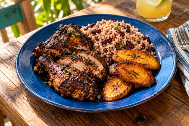 Illustration: Jamaican Jerk Chicken. Fictional scene; not a photograph of this business or its actual menu.