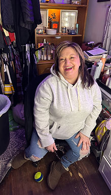 Rhonda Sandy  smiling surrounded by creative chaos.