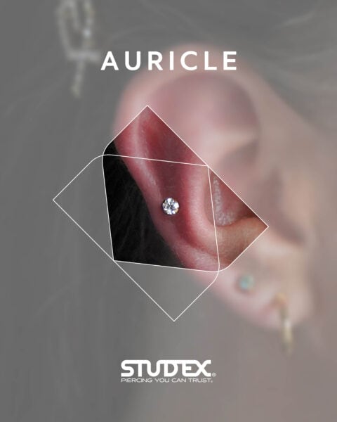 Single auricle piercing with a crystal stud placed along the mid-outer ear, ideal for minimalist, stylish looks using the Studex 75 system.