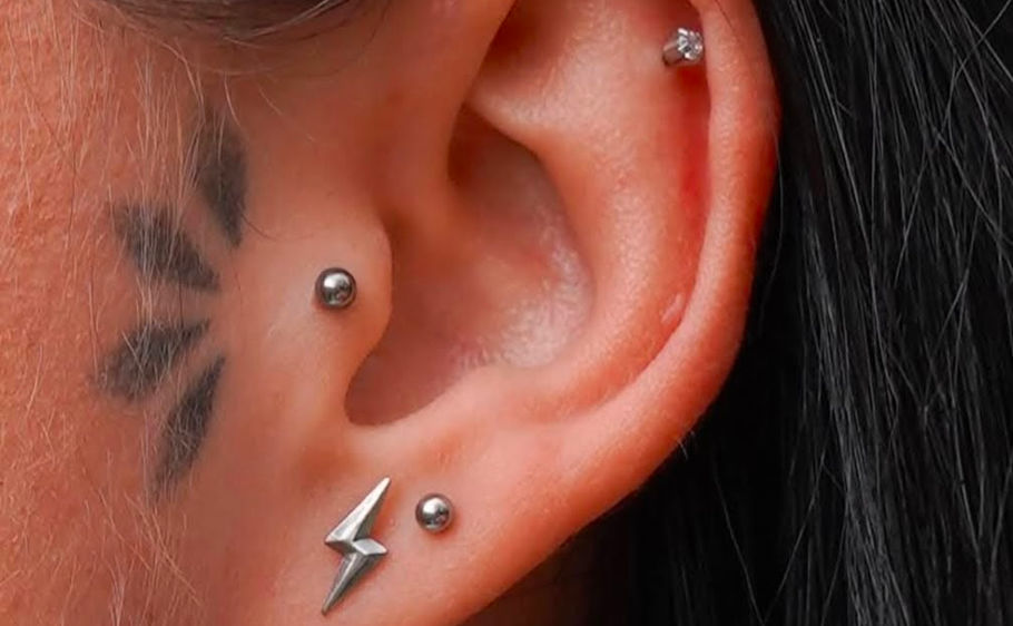Curated ear piercings on client in a private Rhode Island jewelry studio