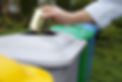 Person placing can in recycling bin