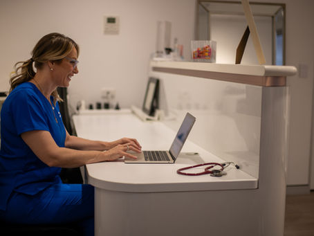 Healthcare professional conducting a telehealth consultation for aesthetic medicine patient care.