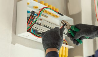 Electrician installing electrical panel
