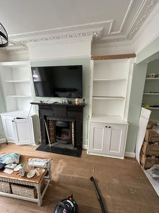 Custom built-in shelving and cabinets around fireplace
