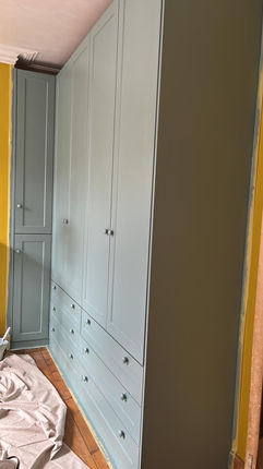 Custom-built pale blue wardrobe with drawers