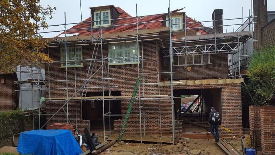 Eye-level view of a construction site with scaffolding and building materials