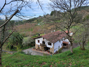 A large home seen from atop a hill