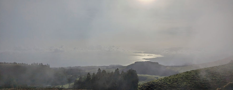 A sun rise over a misty mountain in Azores