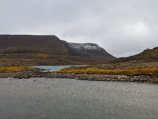 A lake in the mountain with snow