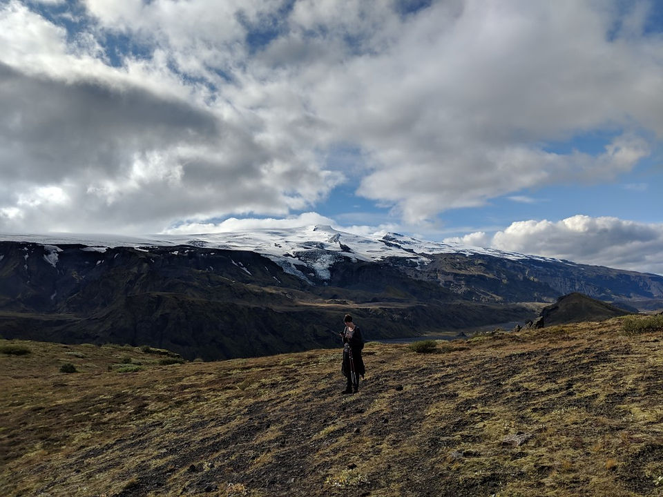 A hiker enjoying the view of Eyjafjöll from Thorsmork