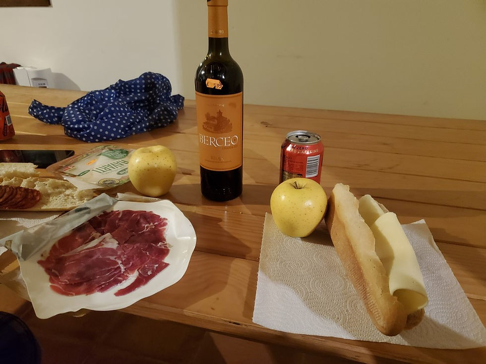 wine, ham and cheese at a table