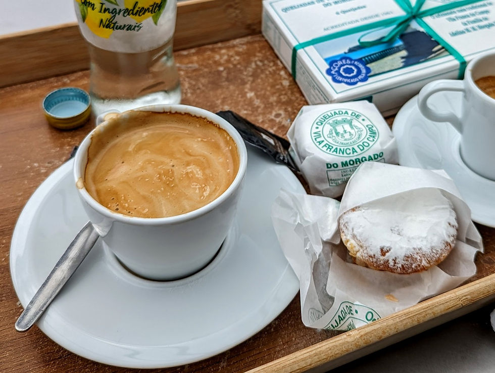 A cup of coffee with queijados tart