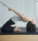 Client performing backbend with springs in classical pilates session Twickenham