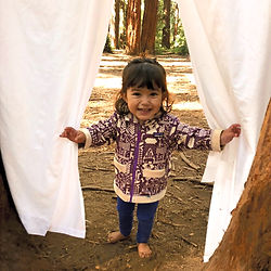Child playing hide and seek in the forest