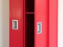 Red school lockers, free standing, with wooden peak roof on top, with 3 only long doors.jp