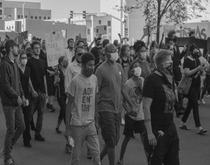 Black and white photo of the artist husband and two sons marching in a peaceful Black Lives Matter protest in Colorado Springs.