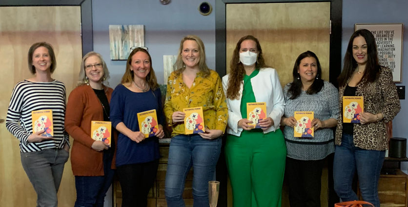 Groups of women each holding an autographed copy of the book, 'Authentic Power' by Ashley Bernardi.