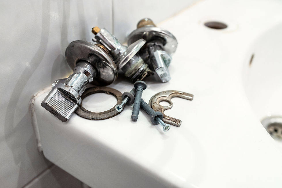 faulty ball valve and fixtures lie on edge of sink