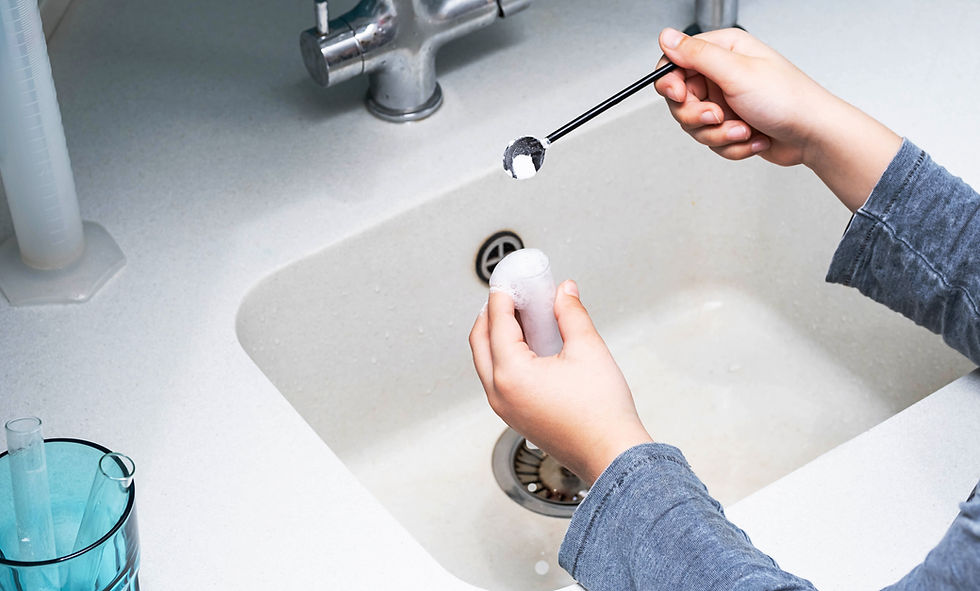 Boy Making Experiments with Vinegar and Baking Soda at Kitchen.