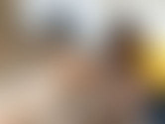 Man repairs a water heater while using a flashlight in a modern bathroom during daytime