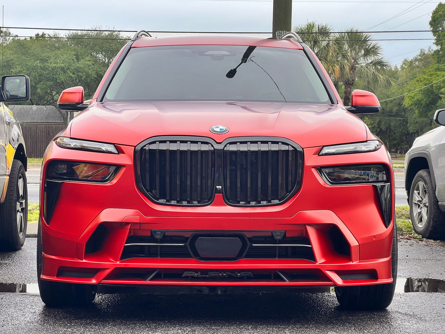 Custom car wrap, red BMW SUV, luxury vehicle wrap, sleek car design, dynamic BMW styling, unique car appearance.