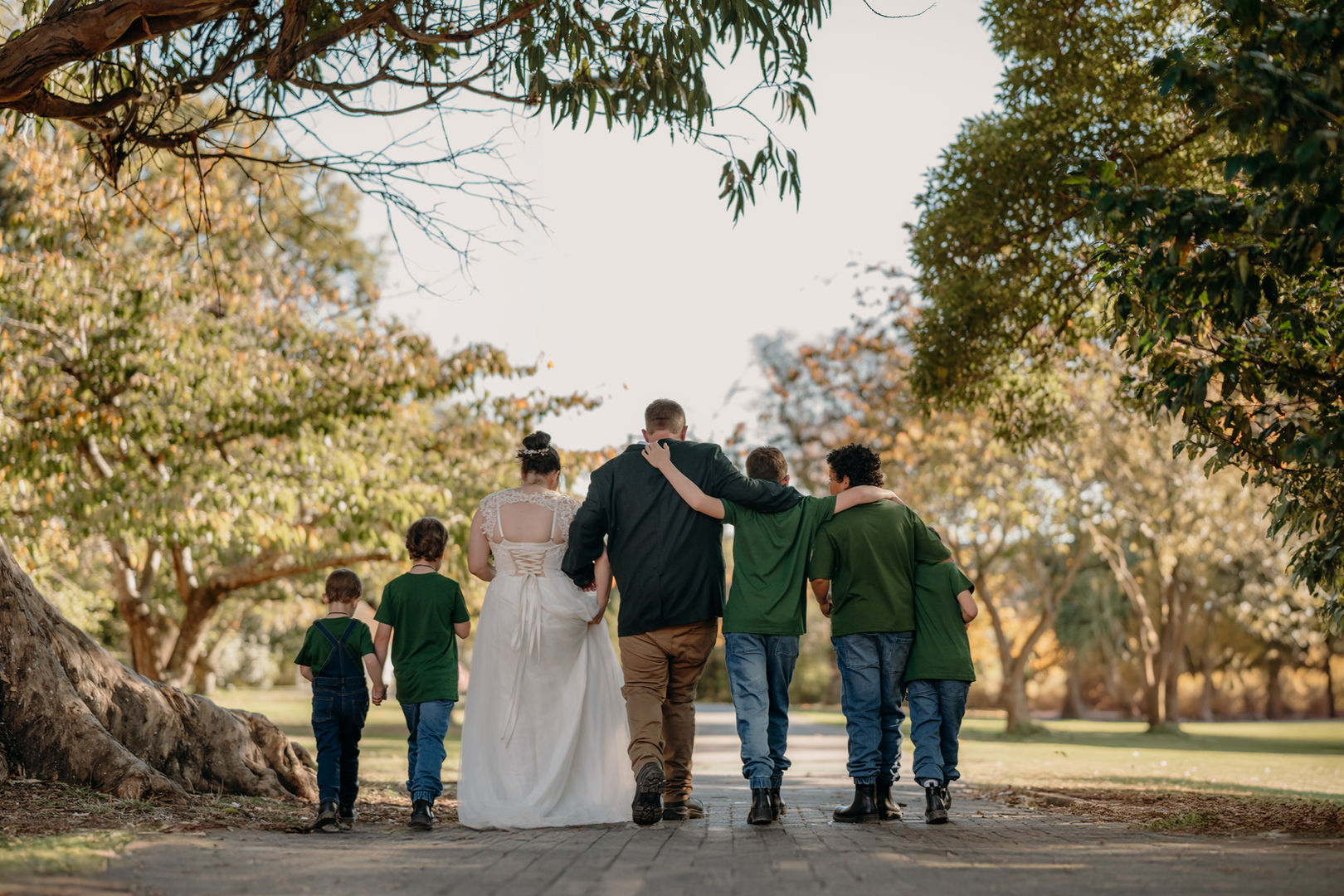 A bride and groom under a tree during wedding photosoot in the Christchurch Botanic Gardens.