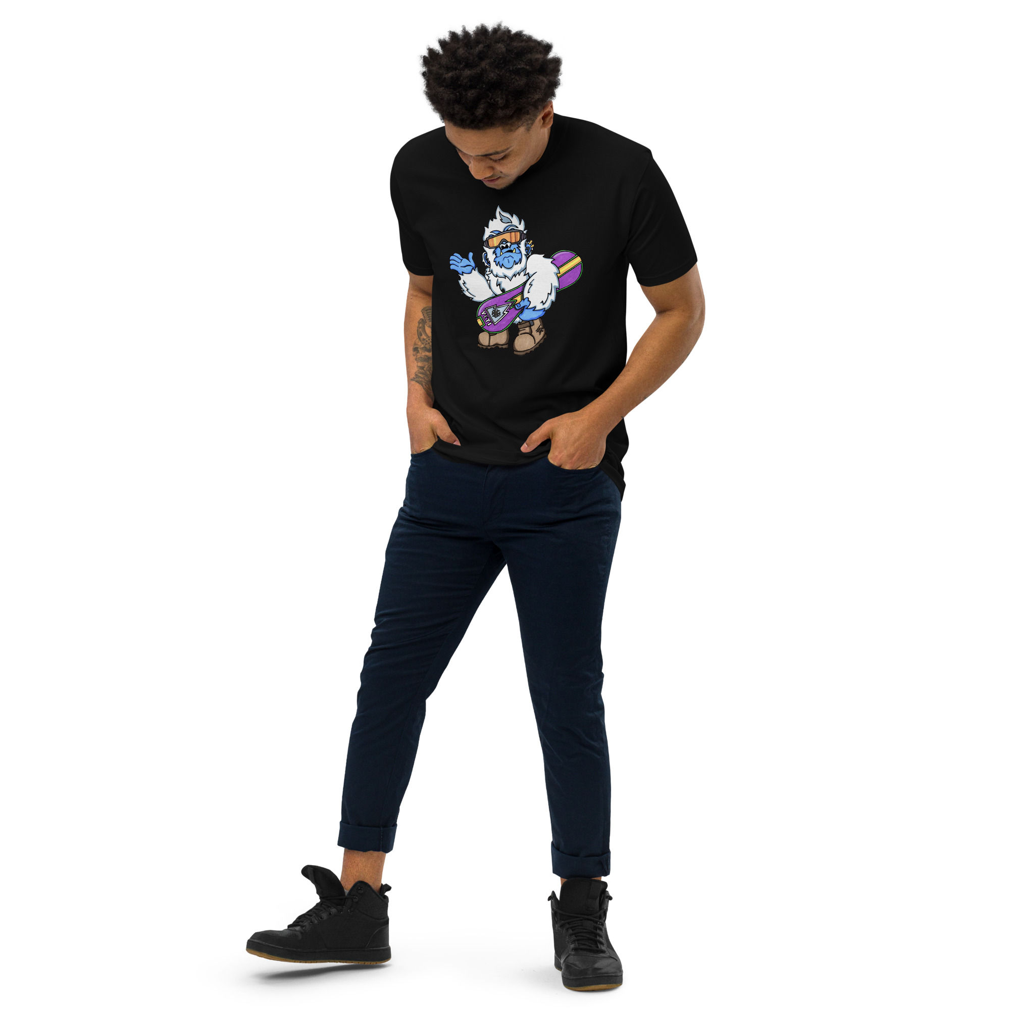 Man wearing a black t-shirt with a Yeti design, black jeans and shoes.