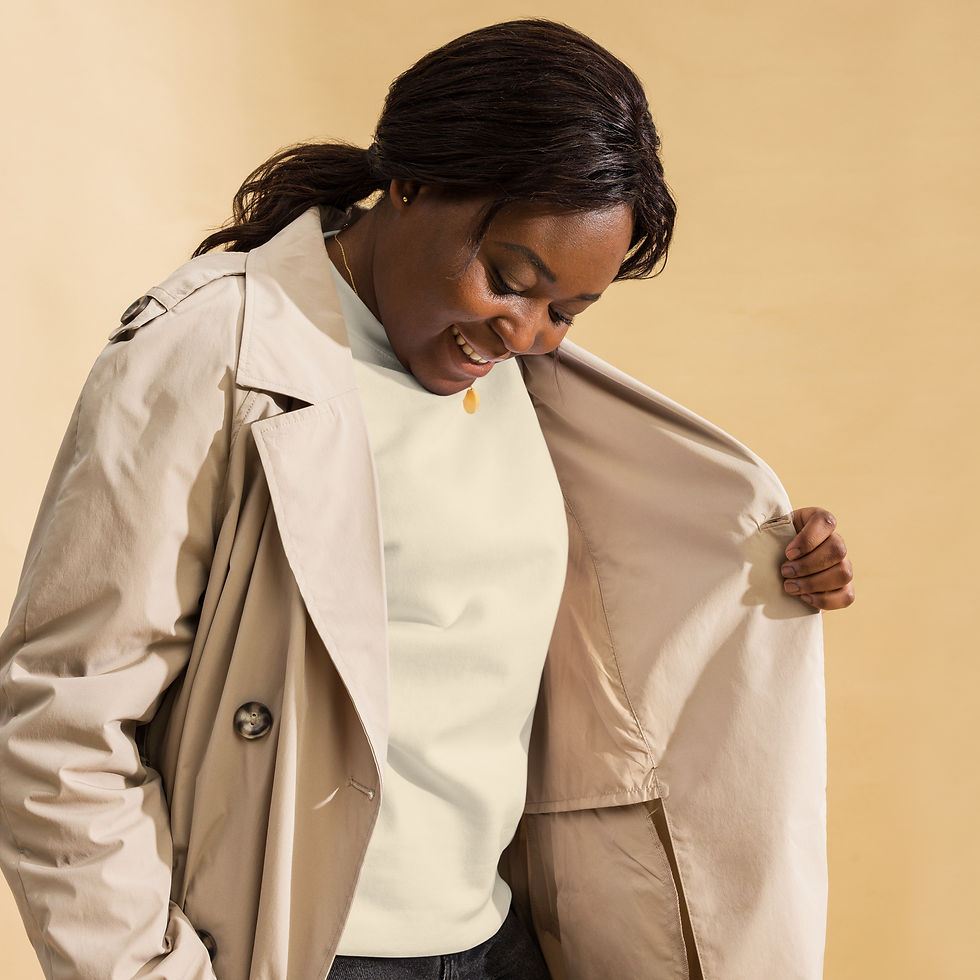 الصورة المصغرة: Smiling woman holding open trench coat, wearing premium sweatshirt. www.r1clothing.com