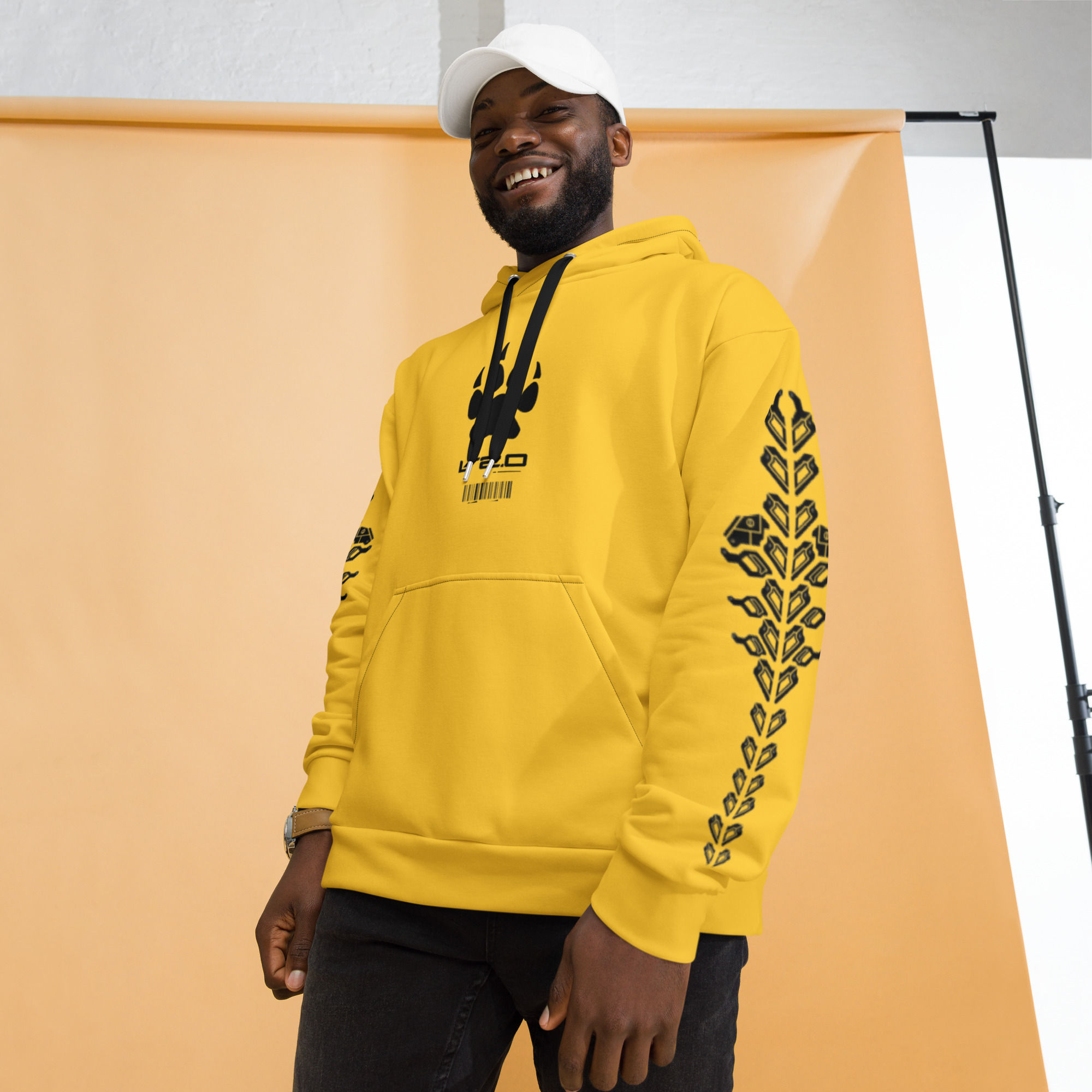 Smiling man wears yellow hoodie with