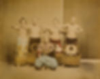 Five men in traditional Japanese clothing, two standing behind and three in front, displaying ceremonial poses.