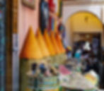 Colourful spice cones and various spices in decorative containers in a market.