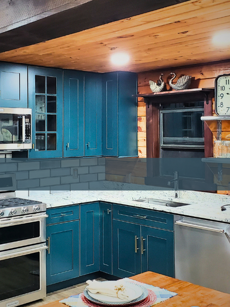 Rustic kitchen with blue cabinets and stainless steel appliances.