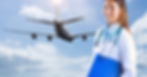 A woman wearing a white coat and stethoscope holds a blue folder. Behind her is an airplane and blue skies.